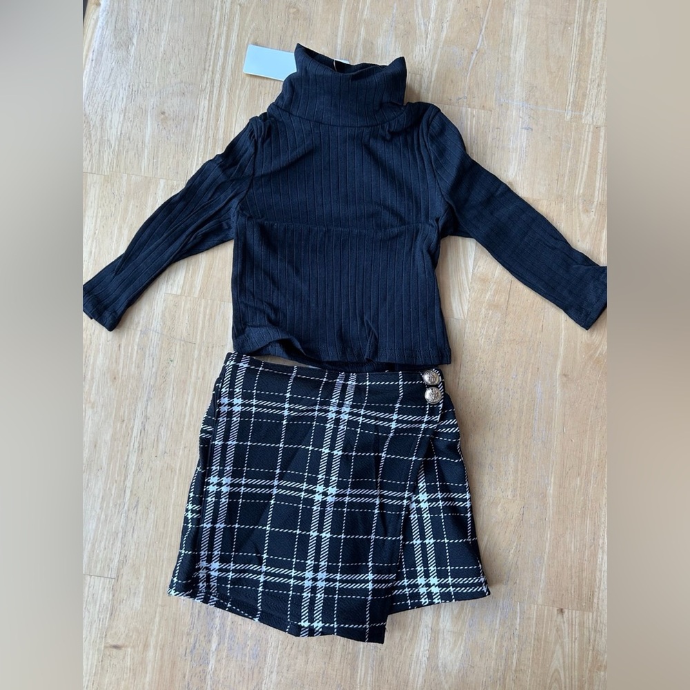 Baby Girls 6/9 months outfit black long sleeve and plaid skirt.